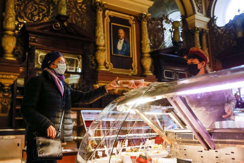 A shopper makes a purchase at the Yeliseyevsky Store. Photo: Reuters