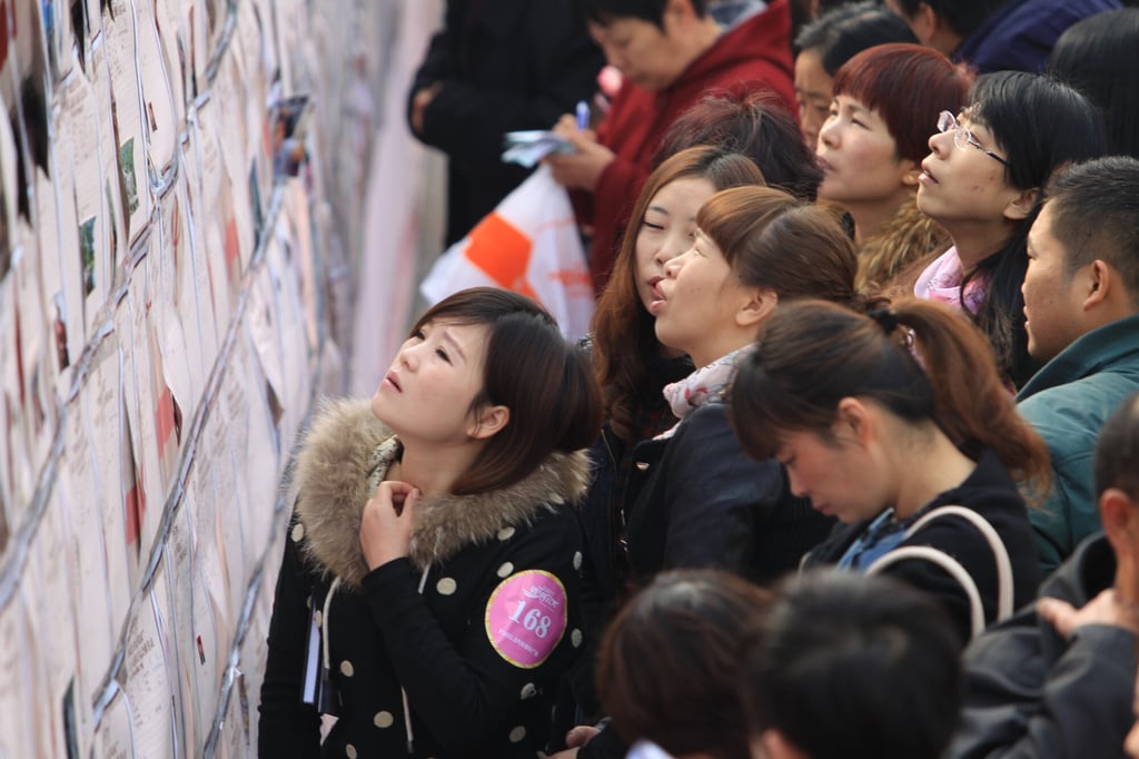 Single participants look at personal information of other bachelors at a mass matchmaking event ahead of Singles Day in Henan province in 2013. Photo: Imaginechina Single participants look at personal information of other bachelors at a mass matchmaking event ahead of Singles Day in Henan province in 2013. Photo: Imaginechina
