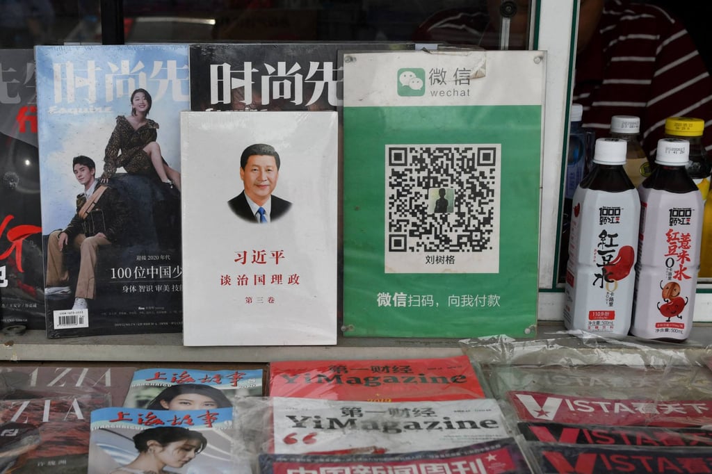 The QR payment code for WeChat Pay is displayed beside a book about Chinese President Xi Jinping at a newsstand in Beijing in August 2020. China has emerged as a world leader in digital payments. Photo: AFP The QR payment code for WeChat Pay is displayed beside a book about Chinese President Xi Jinping at a newsstand in Beijing in August 2020. China has emerged as a world leader in digital payments. Photo: AFP