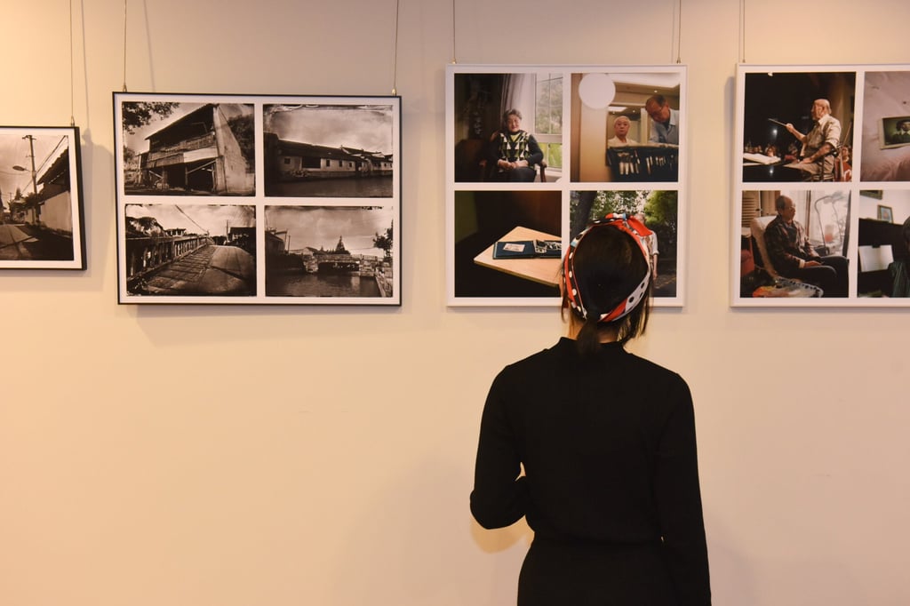 A visitor views exhibits at “Through Her Eyes: Stories of the City by Four Female Photographers”, a show at Space33, an art space within the official residence of the American Consul General in Shanghai. Photo: Space33