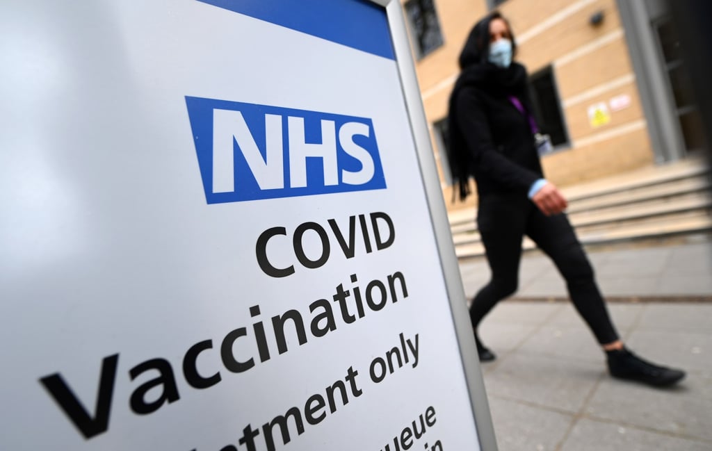 A woman walks past a Covid-19 vaccination centre in London earlier this month. Photo: WPA A woman walks past a Covid-19 vaccination centre in London earlier this month. Photo: WPA