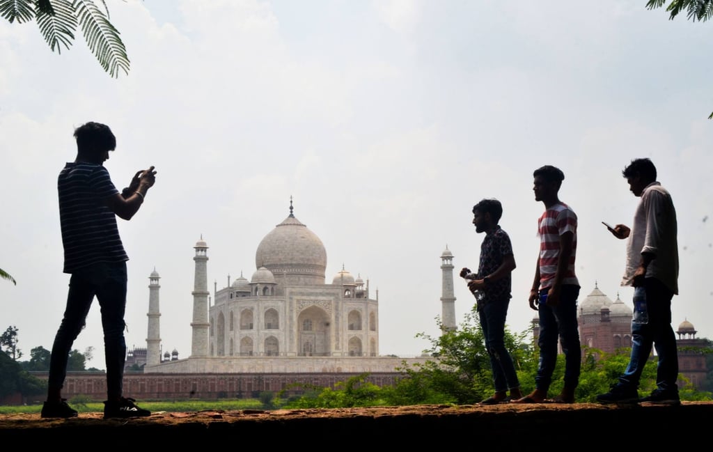 People take pictures with their smartphones near the Taj Mahal in Agra. Photo: AFP People take pictures with their smartphones near the Taj Mahal in Agra. Photo: AFP