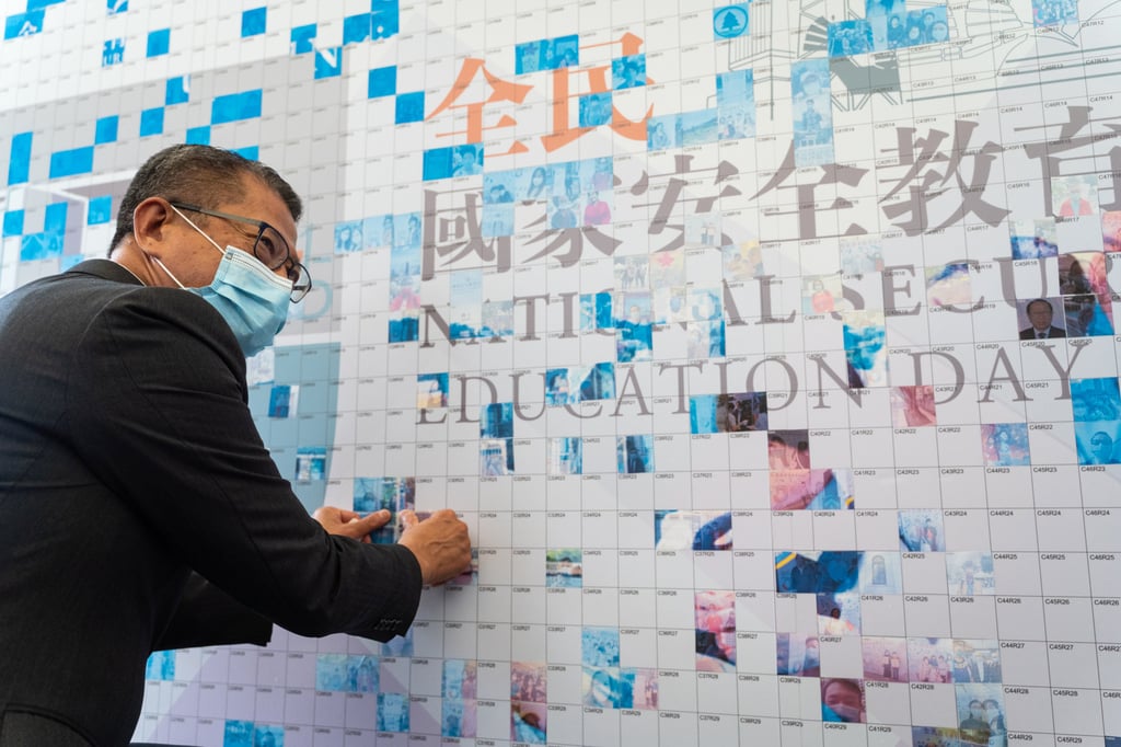 Finance secretary Paul Chan adds his photo to a mosaic of Hongkongers at an event marking National Security Education Day on Thursday. Photo: Bloomberg Finance secretary Paul Chan adds his photo to a mosaic of Hongkongers at an event marking National Security Education Day on Thursday. Photo: Bloomberg