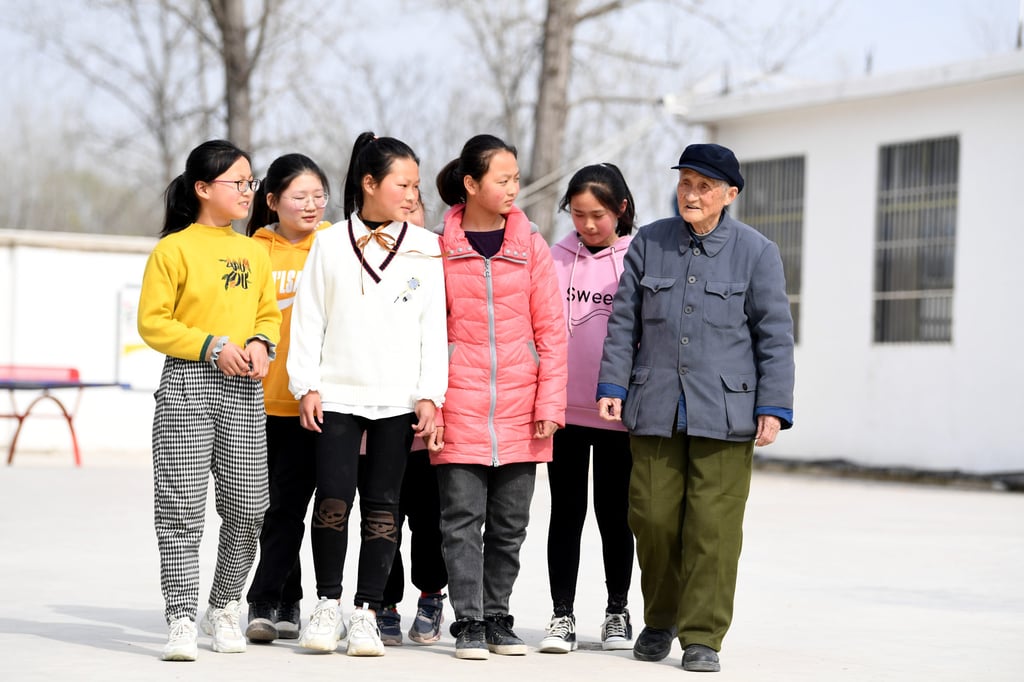 Primary students in Zhuwan township in Chuzhou city, Anuhui province, talk with a former teacher on March 23. In rural areas, the daughters of parents with a stated preference for a son were less likely to attend school and more likely to start work younger. Photo: Xinhua Primary students in Zhuwan township in Chuzhou city, Anuhui province, talk with a former teacher on March 23. In rural areas, the daughters of parents with a stated preference for a son were less likely to attend school and more likely to start work younger. Photo: Xinhua