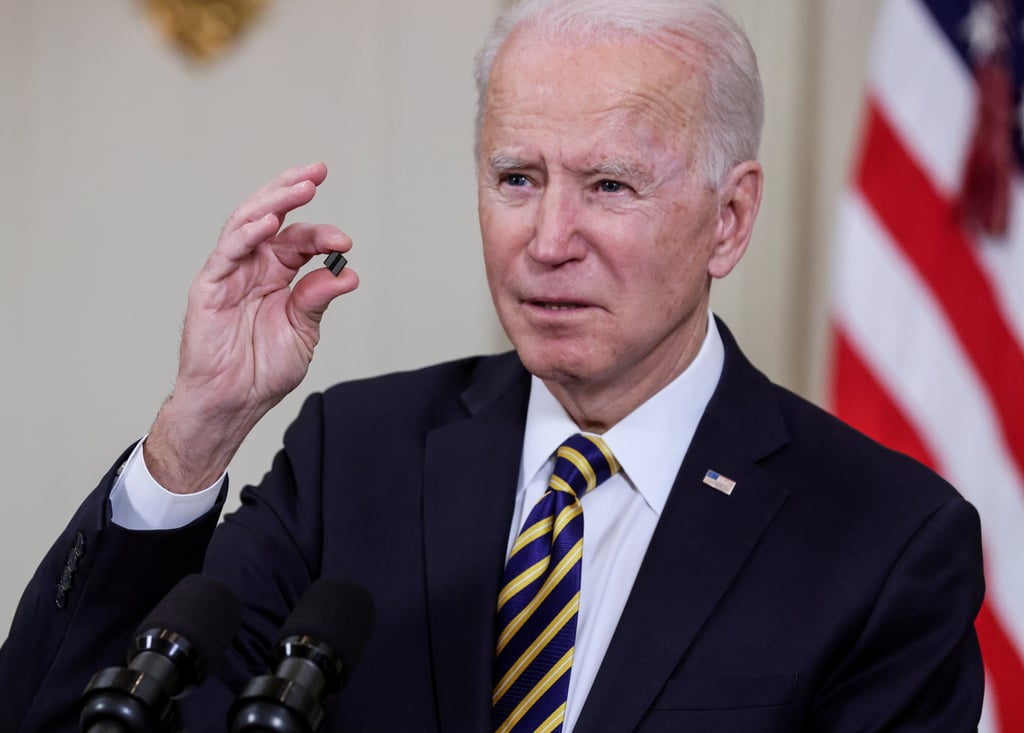US President Joe Biden holds a chip as he speaks before signing an executive order aimed at addressing a global semiconductor shortage, in the State Dining Room at the White House in Washington, DC, on February 24. Photo: Reuters US President Joe Biden holds a chip as he speaks before signing an executive order aimed at addressing a global semiconductor shortage, in the State Dining Room at the White House in Washington, DC, on February 24. Photo: Reuters