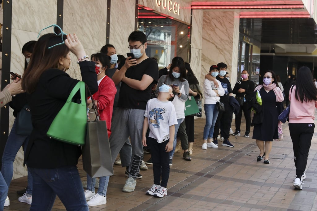 Shoppers in Tsim Sha Tsui, Hong Kong line up in front of luxury stores amid the Covid-19 pandemic in February 2021. Photo: Nora Tam Shoppers in Tsim Sha Tsui, Hong Kong line up in front of luxury stores amid the Covid-19 pandemic in February 2021. Photo: Nora Tam
