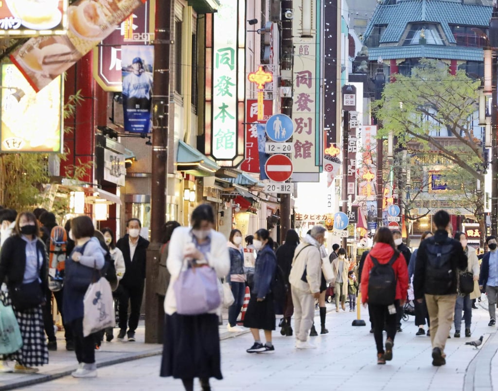 People wearing face masks shop in Yokohama earlier this month. Japan is seen as one of the best placed economies to weather the pandemic. Photo: Kyodo