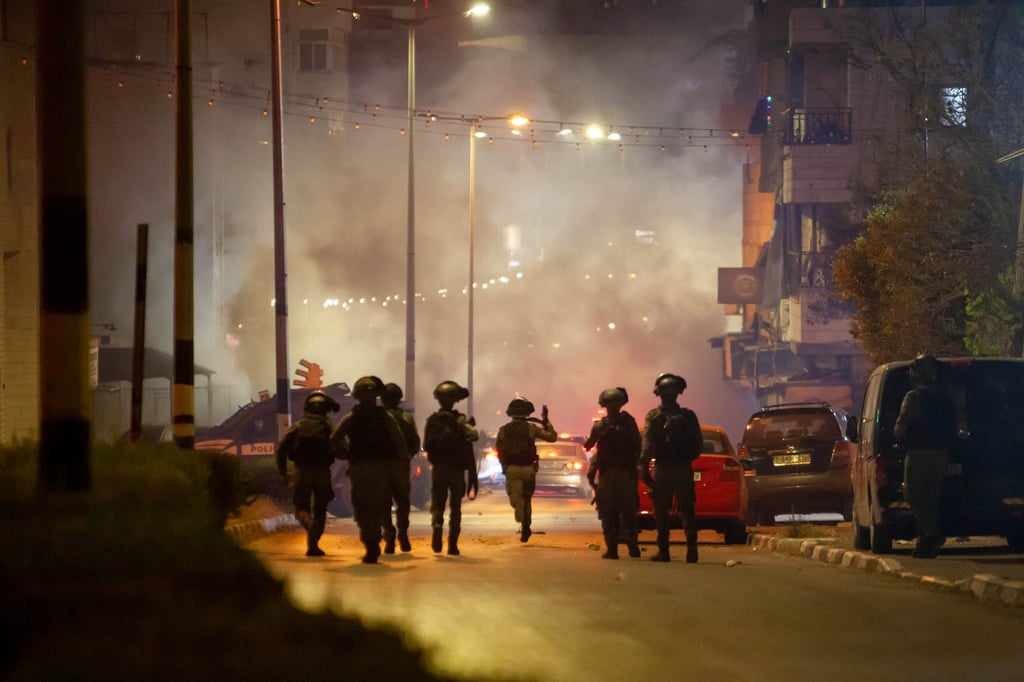 Israeli soldiers hold their weapons during clashes with Palestinians in the West Bank city of Bethlehem on Friday. Photo: Xinhua