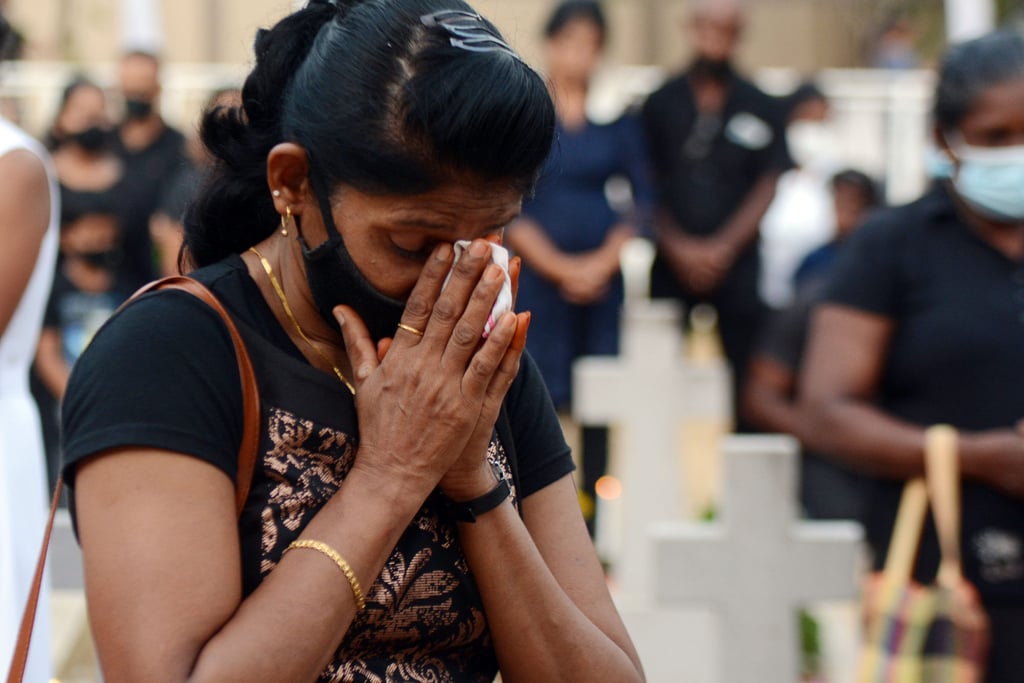 A woman prays during a special service to commemorate the 2019 attacks at a cemetery in Negombo, Sri Lanka, on April 21, 2021. Photo: Xinhua