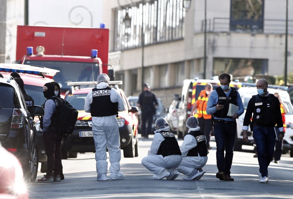Officers investigate near the entrance of the police station in Rambouillet, France, on Friday after a fatal knife attack. Photo: EPA-EFE