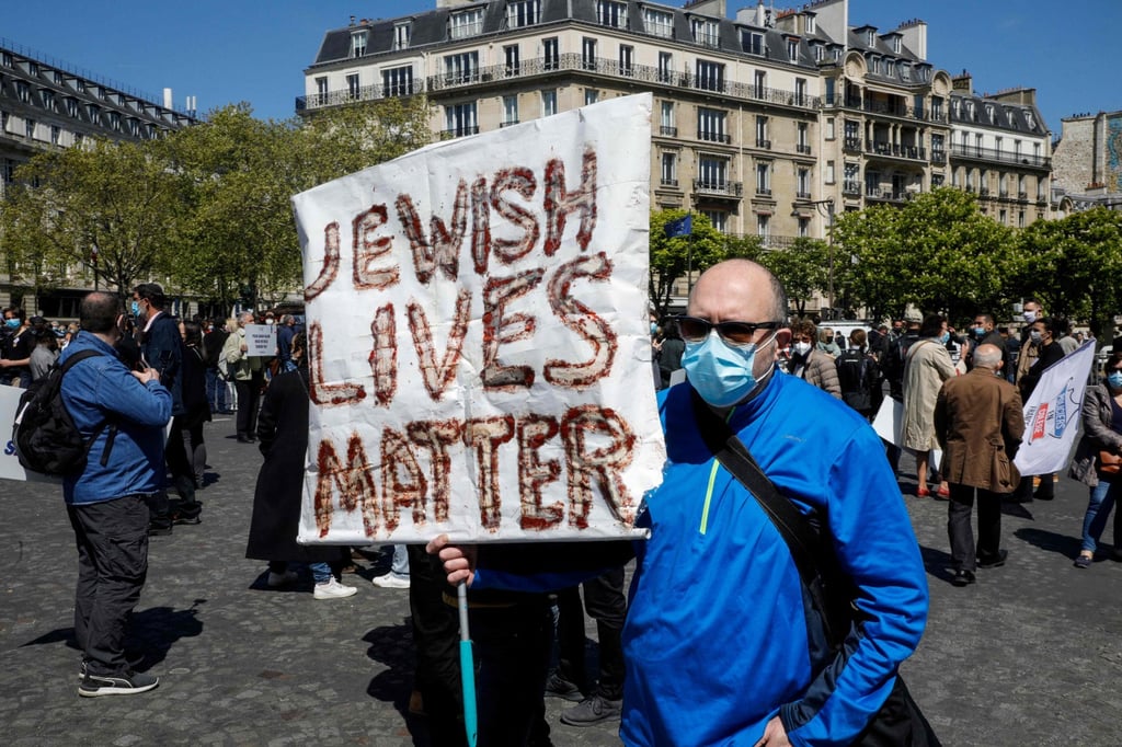A protester holds a placard as people demand justice for Sarah Halimi in Trocadero Plaza in Paris on Sunday. Photo: AFP A protester holds a placard as people demand justice for Sarah Halimi in Trocadero Plaza in Paris on Sunday. Photo: AFP
