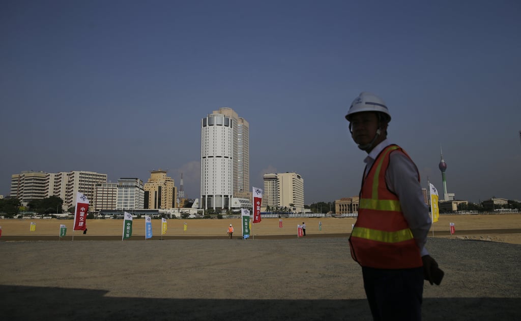 A Chinese construction worker, on land reclaimed from the Indian Ocean for the Port City Colombo project. Photo: AP