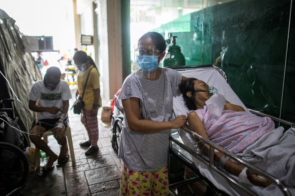 Patients are treated outside a government hospital in Quezon City that declared overcapacity on Monday amid rising numbers of Covid-19 infections in Metro Manila. Photo: Reuters