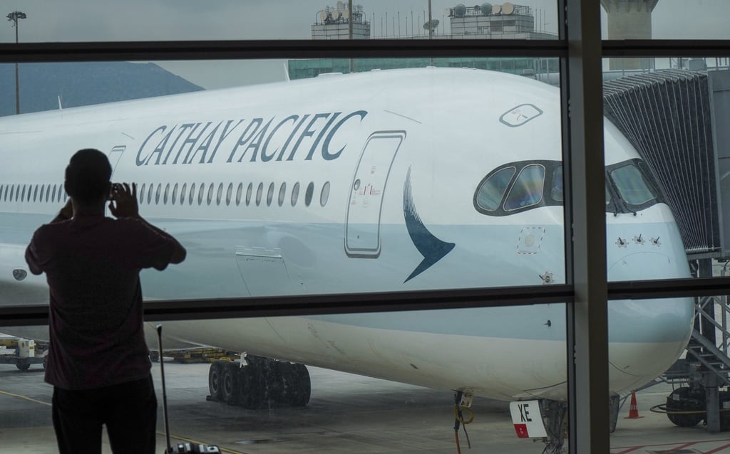 A traveller takes a picture of a Cathay Pacific A350-1000 aircraft parked at Hong Kong International Airport. Photo: Roy Issa