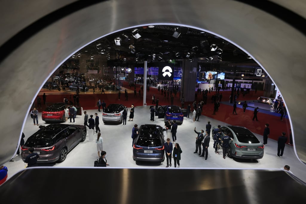 Visitors look at the latest cars from Chinese automaker NIO during the Shanghai car show. Photo: AP Photo