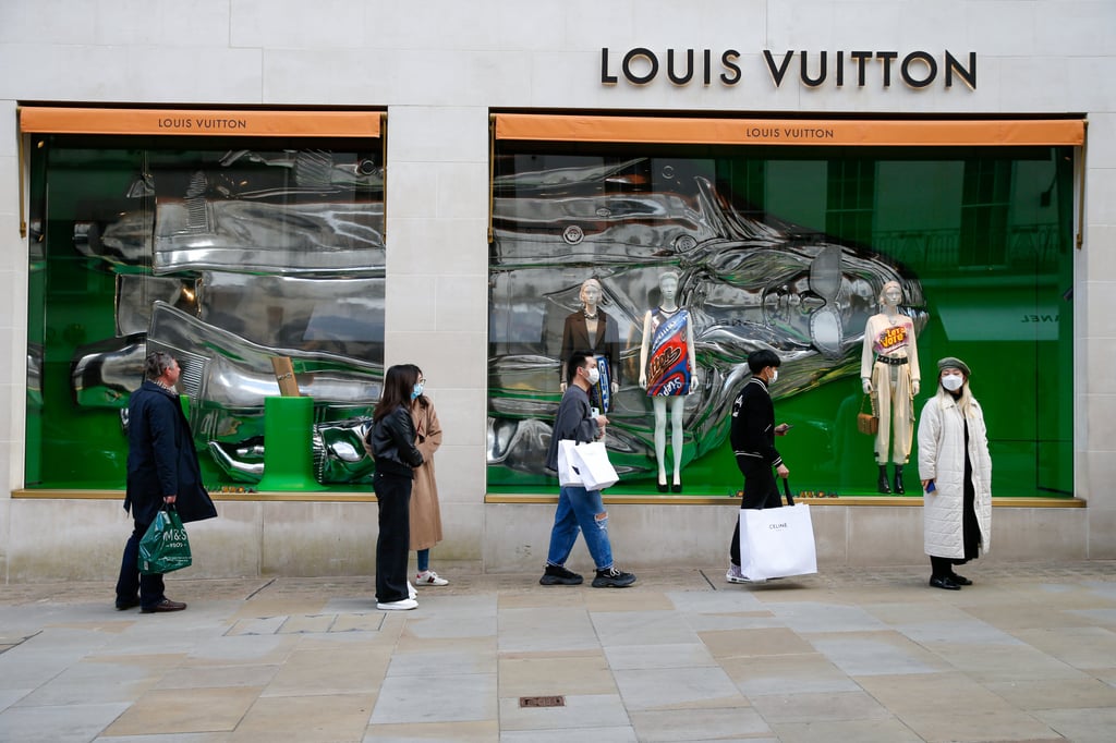 Shoppers queue outside a Louis Vuitton luxury goods store, operated by LVMH, in London, in April 2021. Photo: Bloomberg Shoppers queue outside a Louis Vuitton luxury goods store, operated by LVMH, in London, in April 2021. Photo: Bloomberg