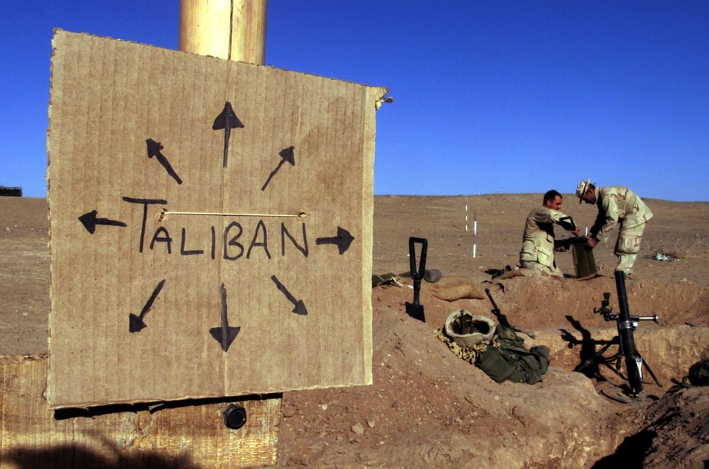 US marines fill sandbags near a cardboard sign reminding everyone that Taliban forces could be anywhere and everywhere, in southern Afghanistan in December 2001. Photo: Reuters