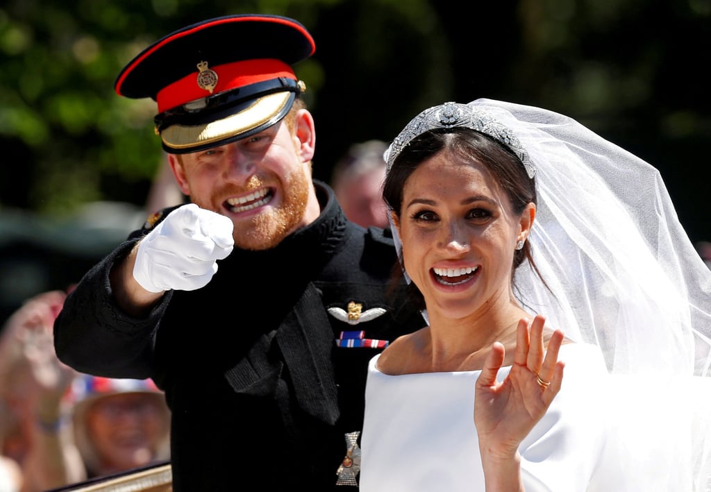 Britain’s Prince Harry next to his wife Meghan Markle as they ride a horse-drawn carriage after their wedding ceremony at St George’s Chapel in Windsor Castle on May 19, 2018. Photo: Reuters