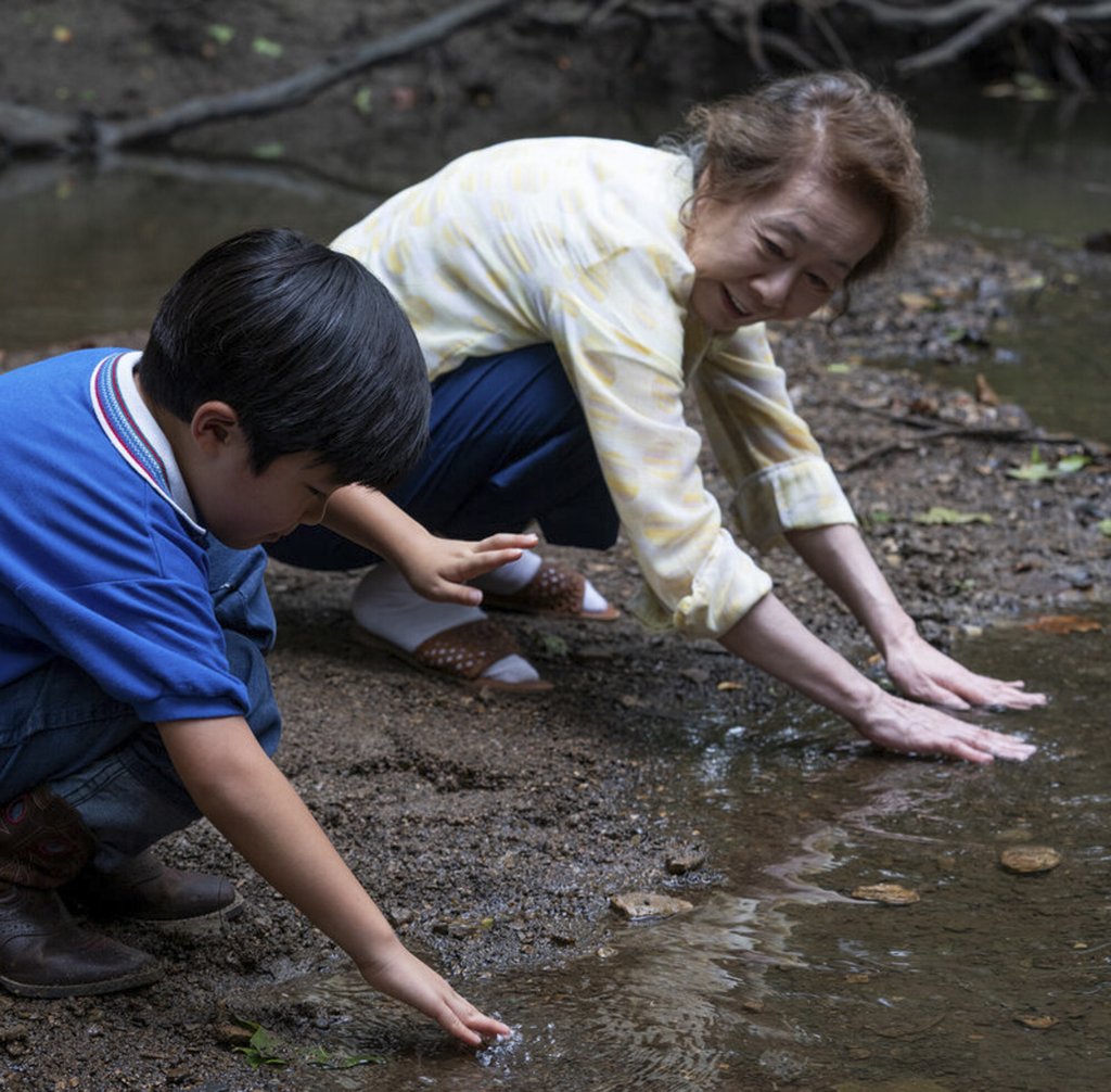 Alan S. Kim (left) and Youn in a scene from Minari. Alan S. Kim (left) and Youn in a scene from Minari.