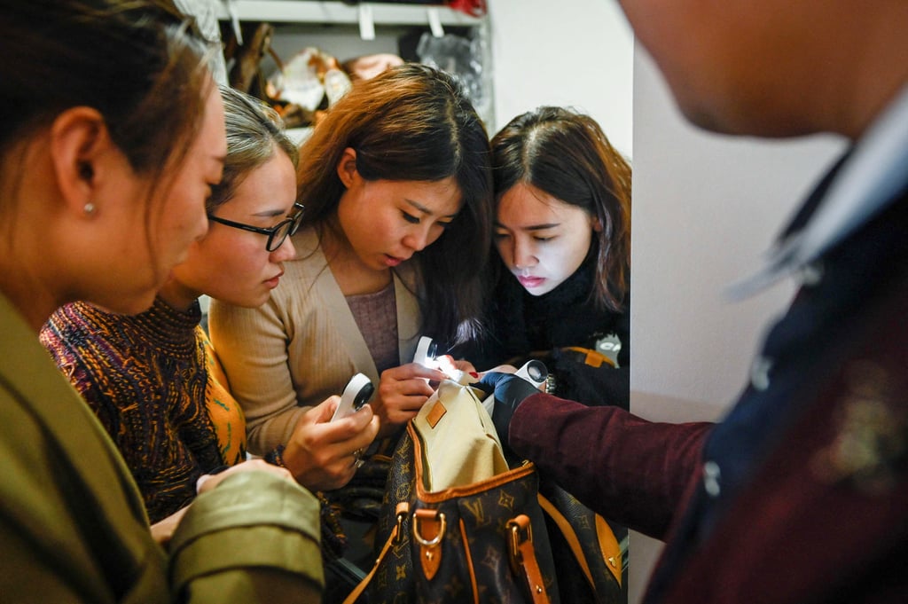Trainees practising methods to verify the authenticity of a handbag following a class at the Extraordinary Luxuries Business School in Beijing in March 2021. Photo: AFP Trainees practising methods to verify the authenticity of a handbag following a class at the Extraordinary Luxuries Business School in Beijing in March 2021. Photo: AFP