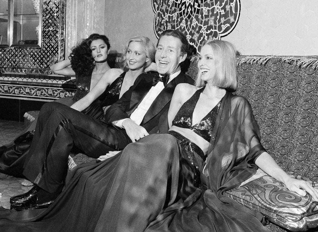 Halston laughs with three of his models at the Iranian Embassy in Washington, before the start of a benefit fashion show, in 1977. Photo: AP Halston laughs with three of his models at the Iranian Embassy in Washington, before the start of a benefit fashion show, in 1977. Photo: AP