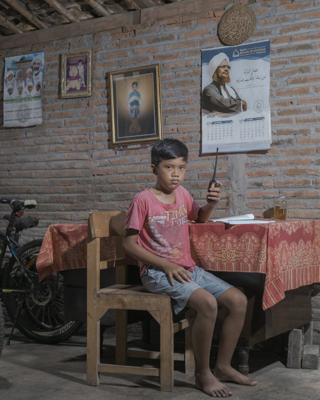 Melvin Saputra, 12: “Because the school was closed, I couldn’t play football with my friends. I like playing football during lunch break.” Photo: Agoes Rudianto Melvin Saputra, 12: “Because the school was closed, I couldn’t play football with my friends. I like playing football during lunch break.” Photo: Agoes Rudianto