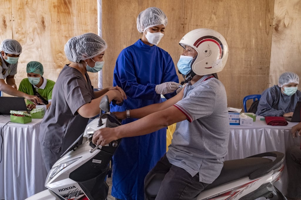 A man receives a Covid-19 jab at a drive-through vaccination centre in Kuta, Bali. Photo: EPA