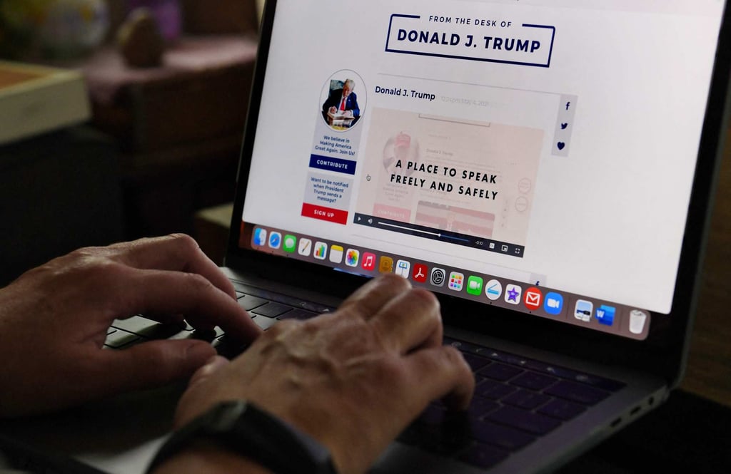 A woman looks at former US president Donald Trump’s new social media platform Straight From The Desk in May 2021. Photo: AFP