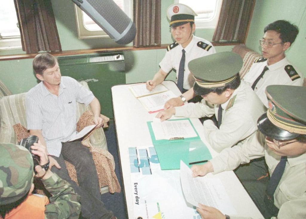 The captain of MV Greenpeace, Ulf Brgander (left), with Chinese authorities on June 12, 1996 as the vessel is refused entry into Shanghai. Photo: Greenpeace