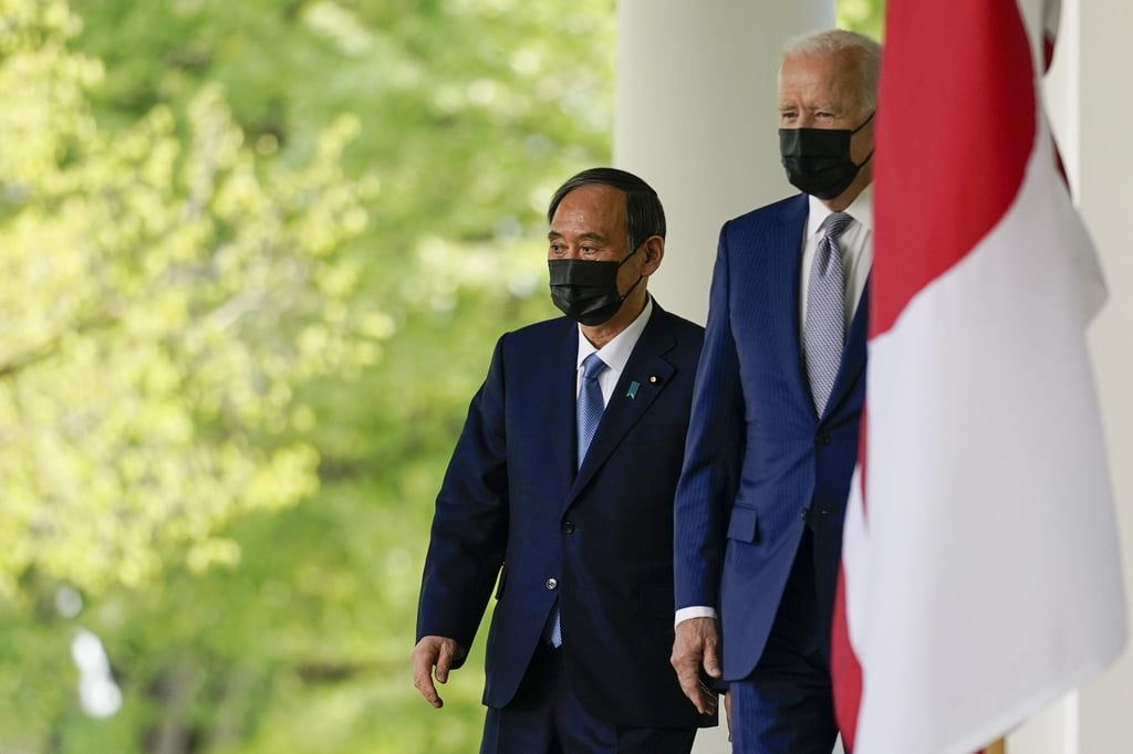 Japanese Prime Minister Yoshihide Suga walks with US President Joe Biden towards the White House Rose Garden, in Washington on April 16. Photo: AP