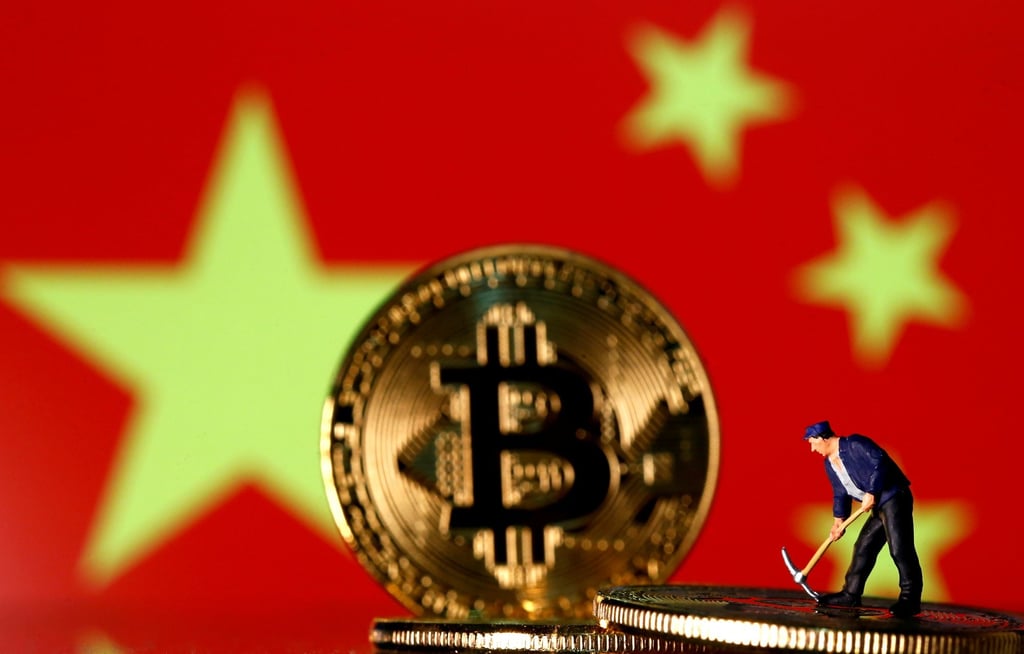A small toy figurine is seen on representations of the bitcoin virtual currency displayed in front of an image of China’s flag in this illustration picture. Photo: Reuters A small toy figurine is seen on representations of the bitcoin virtual currency displayed in front of an image of China’s flag in this illustration picture. Photo: Reuters