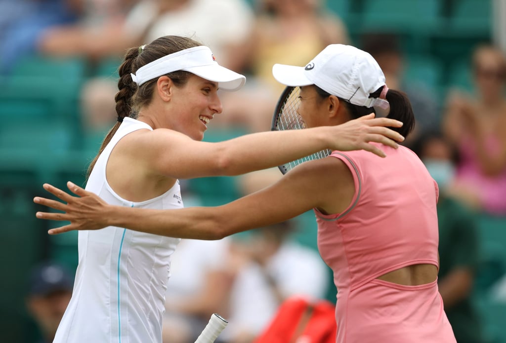 Konta and Zhang embrace at the net after the Briton’s win. Photo: Reuters