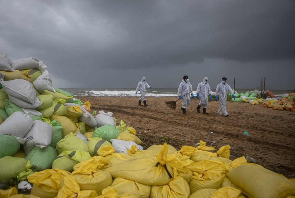Sri Lankan navy soldiers walk on the beach looking for plastic debris washed ashore from fire damaged container ship MV X-Press Pearl on June 14, 2021. Photo: AP