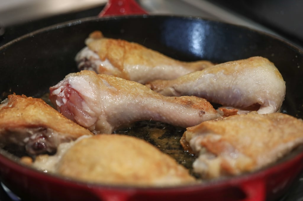 Sear the chicken pieces in the skillet. Photo: Jonathan Wong Sear the chicken pieces in the skillet. Photo: Jonathan Wong