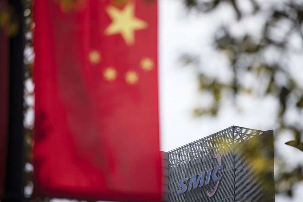 A Chinese flag near a logo atop the Semiconductor Manufacturing International Corp (SMIC) headquarters in Shanghai on March 23. SMIC is China’s biggest chip maker, but it remains years behind overseas rivals in making advanced chips. Photo: Bloomberg A Chinese flag near a logo atop the Semiconductor Manufacturing International Corp (SMIC) headquarters in Shanghai on March 23. SMIC is China’s biggest chip maker, but it remains years behind overseas rivals in making advanced chips. Photo: Bloomberg