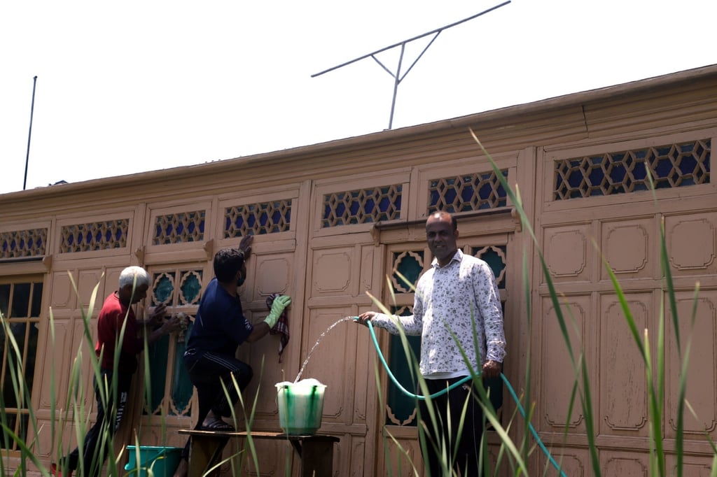 Imtiyaz Ahmad cleans his houseboat, the Young Beauty Star, in the hopes of soon having some paying customers. Photo: Bhat Burhan Imtiyaz Ahmad cleans his houseboat, the Young Beauty Star, in the hopes of soon having some paying customers. Photo: Bhat Burhan