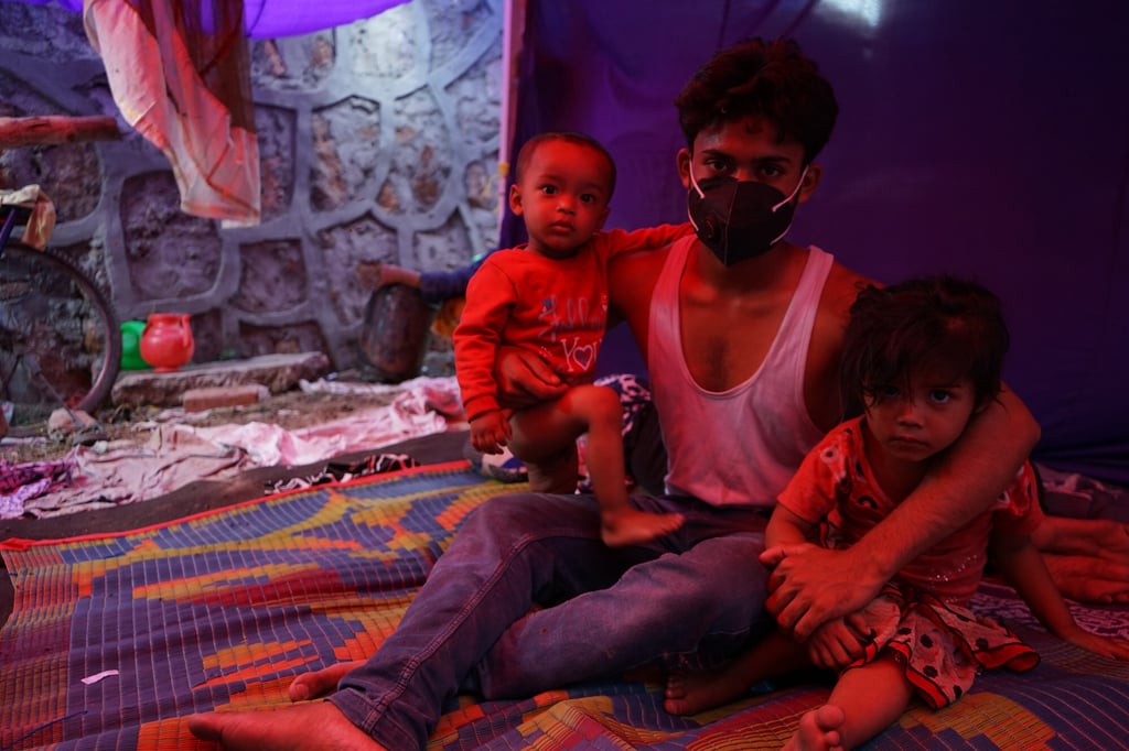 Hilal Ud-din with his two children insider their tent in New Delhi. Photo: Adnan Bhat
