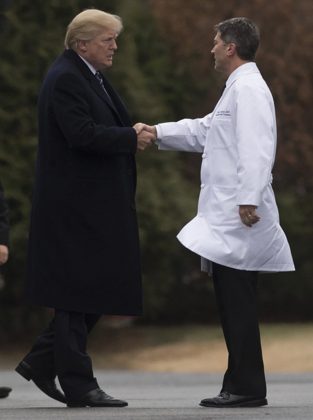US President Donald Trump shakes hands with White House doctor Ronny Jackson, following his annual physical in 2018. Photo: AFP