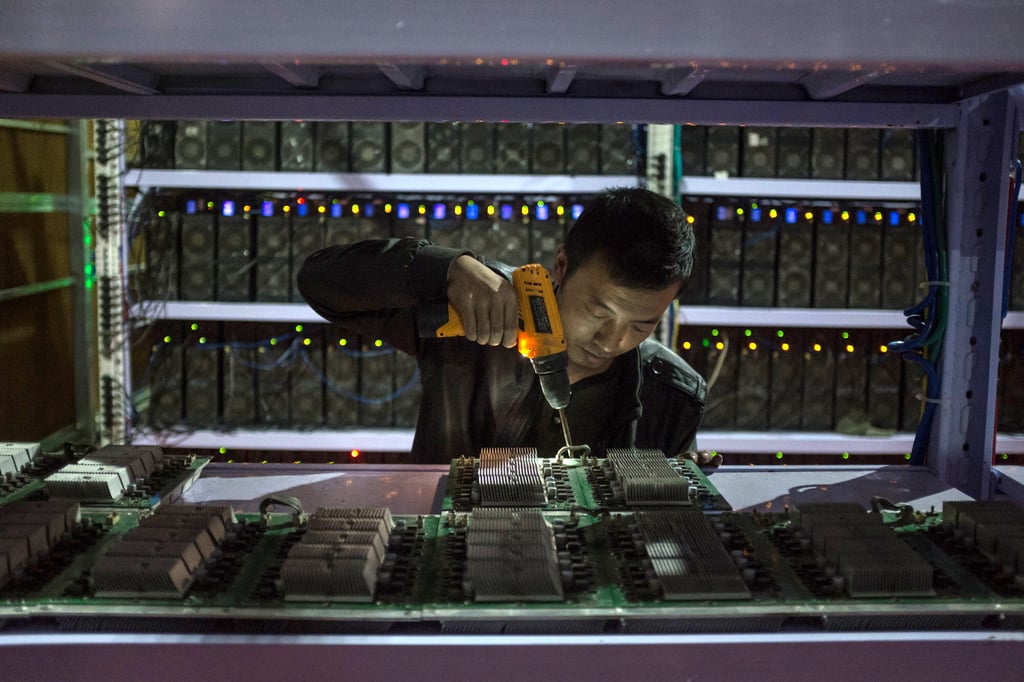 An employee is seen working on a computer motherboard at a bitcoin mining operation in China’s southwestern Sichuan province. Photo: EPA An employee is seen working on a computer motherboard at a bitcoin mining operation in China’s southwestern Sichuan province. Photo: EPA