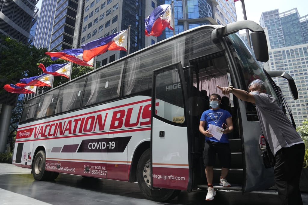 An inoculated man exits a bus used as a mobile Covid-19 vaccination centre in Taguig, Manila. Photo: AP