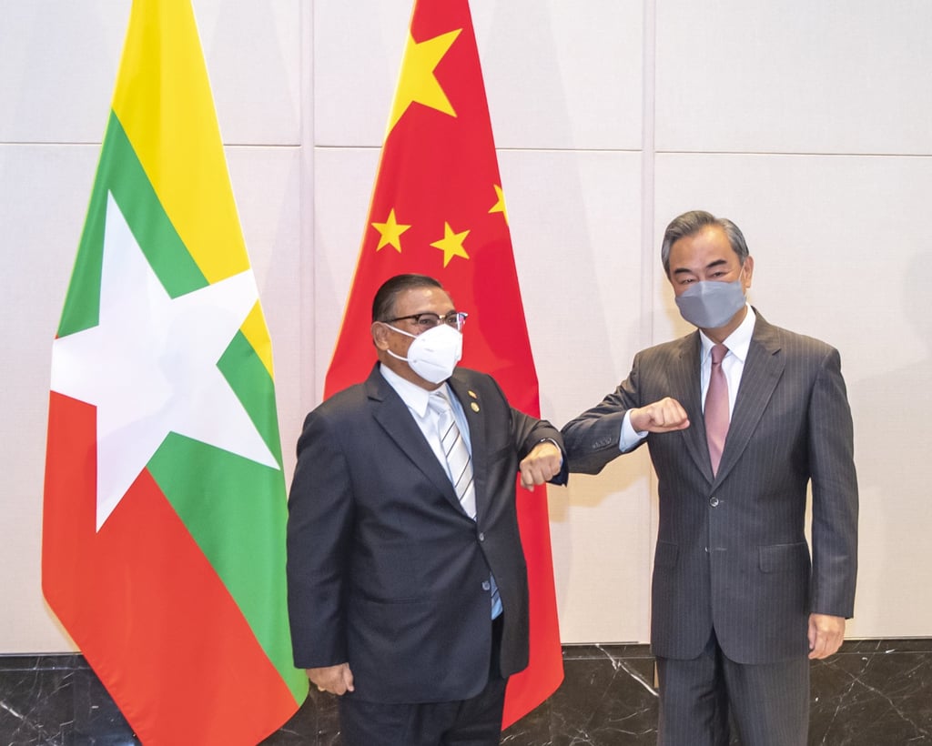 Myanmar’s Foreign Minister U Wunna Maung Lwin bumps elbows with Chinese Foreign Minister Wang Yi in Chongqing. Photo: AP