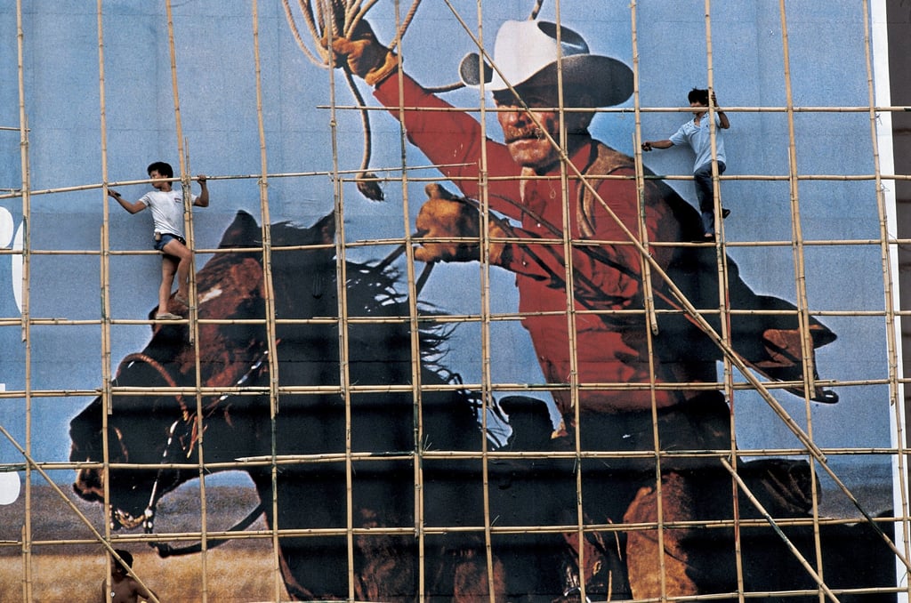 Workers put up scaffolding over an advert featuring the Marlboro Man. Photo: Frank Fischbeck Workers put up scaffolding over an advert featuring the Marlboro Man. Photo: Frank Fischbeck