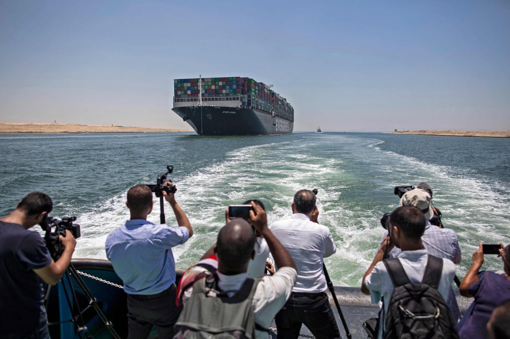 Journalists on a nearby boat film the Ever Given container ship sailing along Egypt’s Suez Canal near the canal’s central city of Ismailia on July 5. The ship that blocked the Suez Canal for six days in March headed for Rotterdam on July 7 after Egyptian authorities and the Japanese owner agreed on a compensation deal. Photo: AFP Journalists on a nearby boat film the Ever Given container ship sailing along Egypt’s Suez Canal near the canal’s central city of Ismailia on July 5. The ship that blocked the Suez Canal for six days in March headed for Rotterdam on July 7 after Egyptian authorities and the Japanese owner agreed on a compensation deal. Photo: AFP