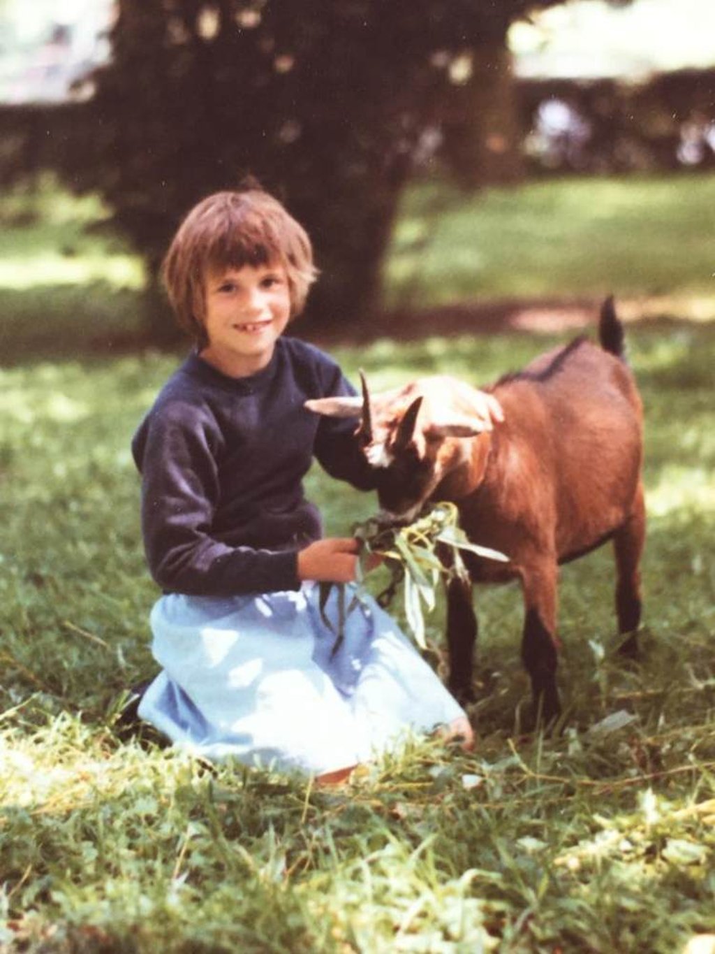 Goethals as an eight-year-old in Belgium with her favourite goat. Photo: Courtesy of Virginie Goethals