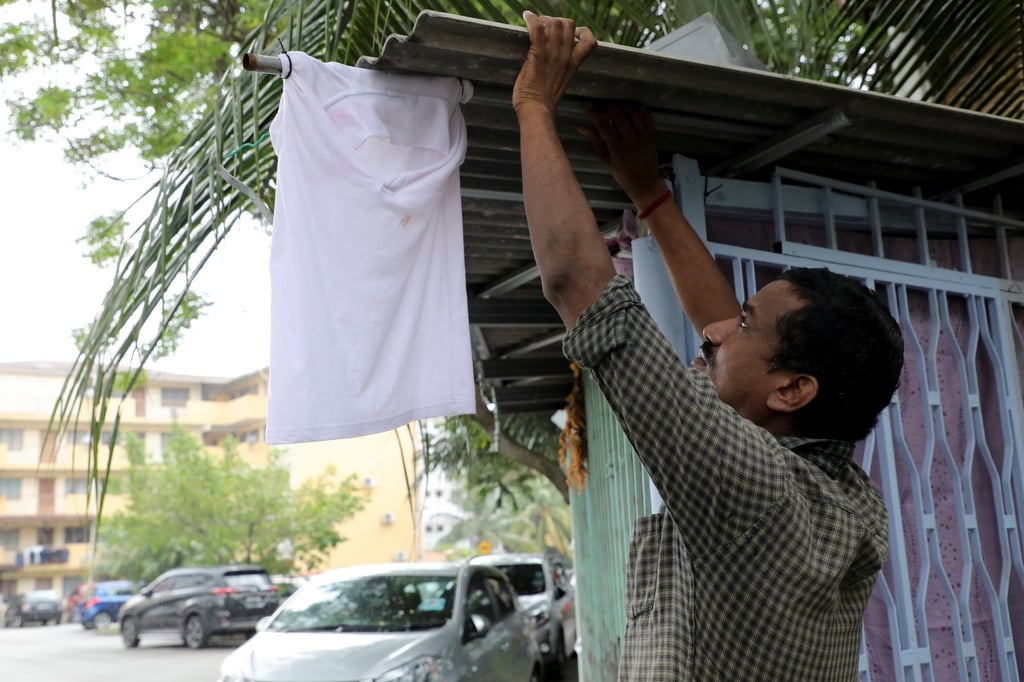 A car cleaner who lost his job during the lockdown hangs a white flag outside his home to seek help from members of the public in Kuala Lumpur on July 5. Photo: Reuters A car cleaner who lost his job during the lockdown hangs a white flag outside his home to seek help from members of the public in Kuala Lumpur on July 5. Photo: Reuters