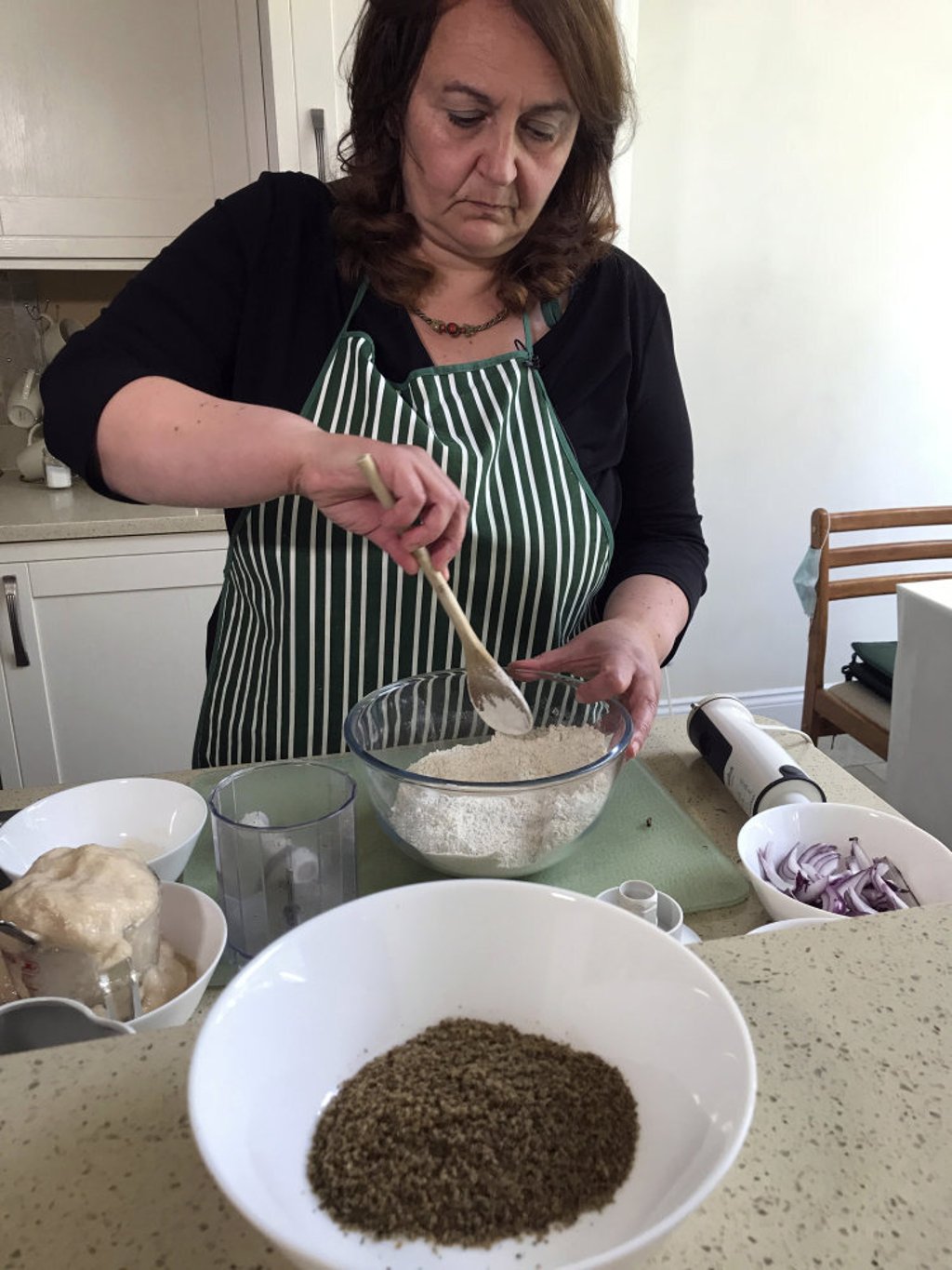 Di Costanzo stirs flour for pizza dough before adding cricket powder (in foreground). Photo: AP