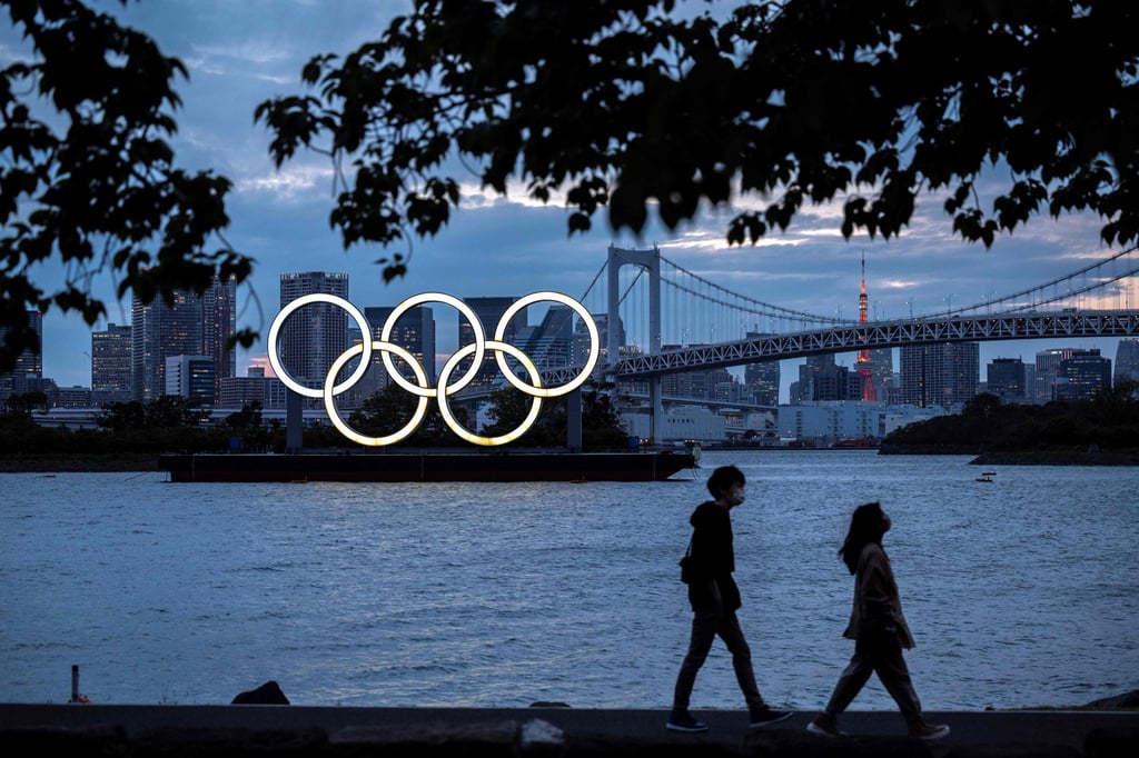 The Olympic rings lit up at dusk on the Odaiba waterfront in Tokyo – where public sentiment is increasingly against staging the games this summer amid soaring coronavirus figures. Photo: AFP