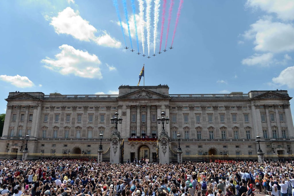 Crowds gather outside as members of the royal family stand on the balcony of Buckingham Palace to watch a fly-past by the Royal Air Force in June 2017. Photo: AFP Photo