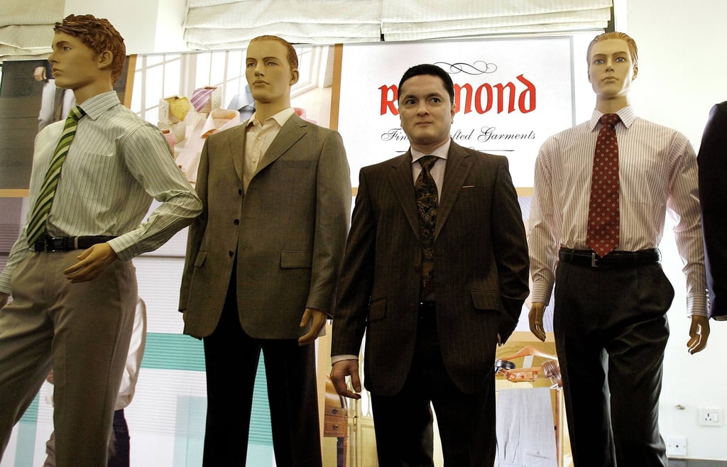 Gautam Singhania, chairman and managing director of fabric and fashion retailer Raymond Group, poses with mannequins at a press conference in Mumbai, India, in December 2007. Photo: AFP