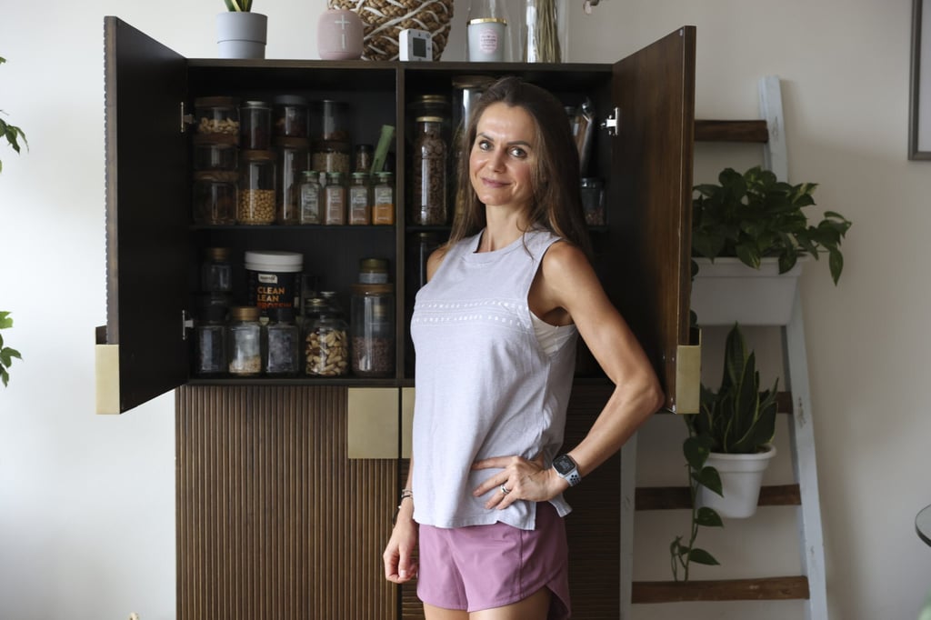 Areington shows some of the plant-based whole foods in her cupboards. Photo: May Tse